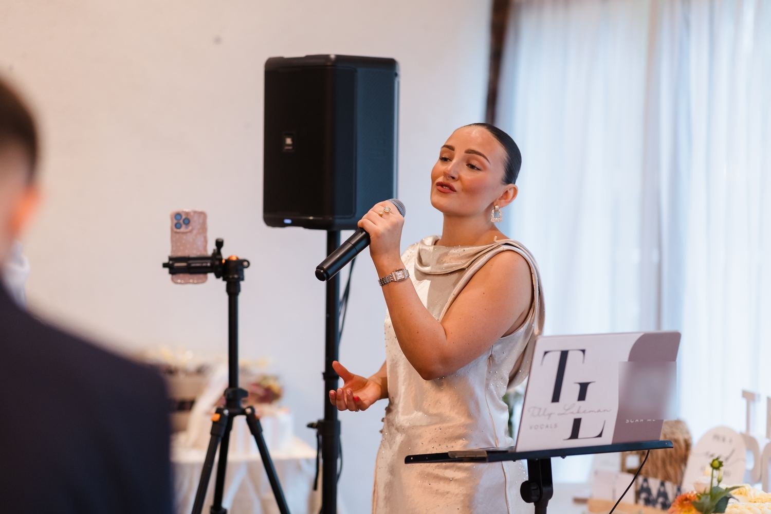 Singer Tilly Lukeman performing live during Abbie and Sean's ceremony in the barn at Bennetts Willow Barn