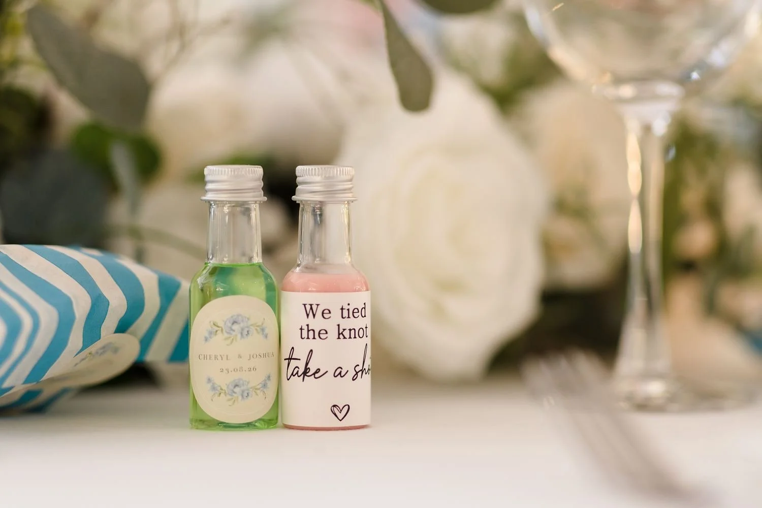 Personalised green and pink wedding shots labelled Cheryl and Joshua and We tied the knot, take a shot