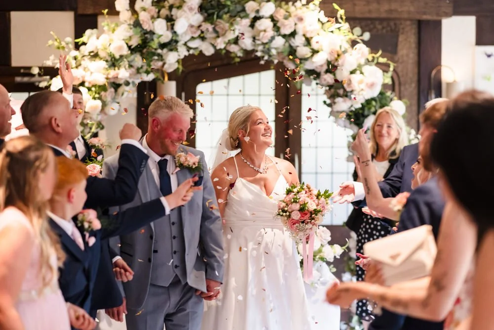 Confetti moment after ceremony at Hogarths Stone Manor with floral arch, Once in a Lifetime Photography