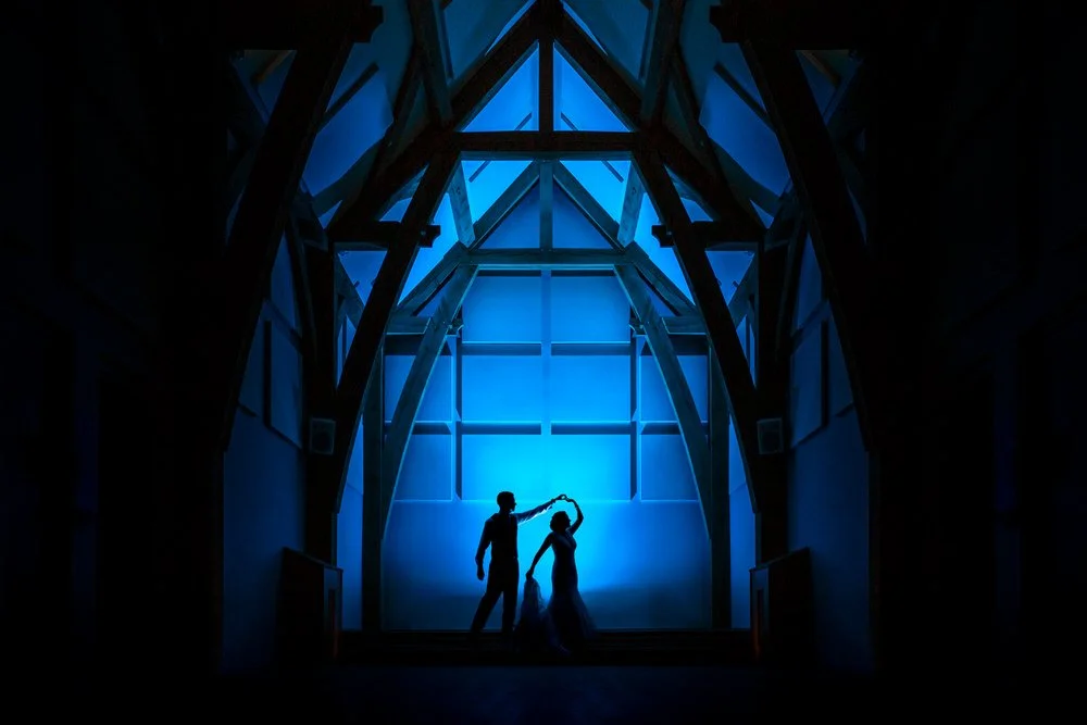 silhouette of bride and groom dancing