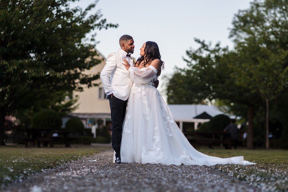 Bride and groom portrait on the gravel path in the grounds of Hogarths Hotel Solihull in golden hour light — documentary wedding photography by Once in a Lifetime Photography, Worcestershire