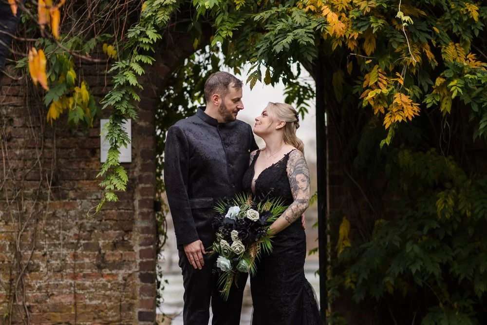 Autumn wedding portrait under historic archway with golden foliage at Arley House, natural couple photography by Once in a Lifetime Photography