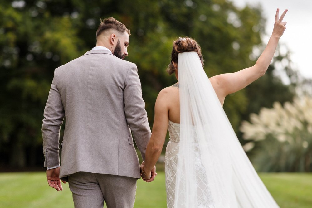 Bride showing the V sign at a wedding