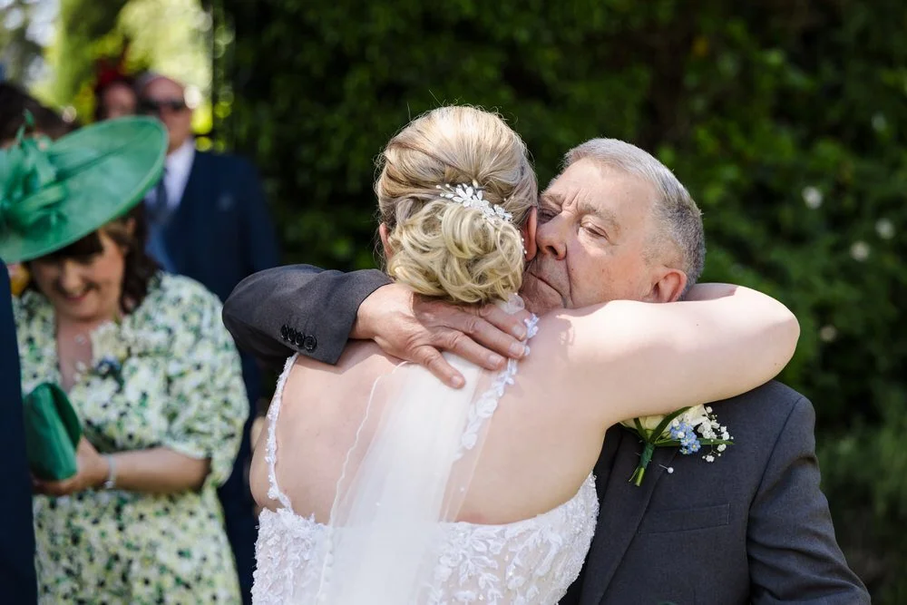 Wedding guest hugging bride at Hogarths Stone Manor