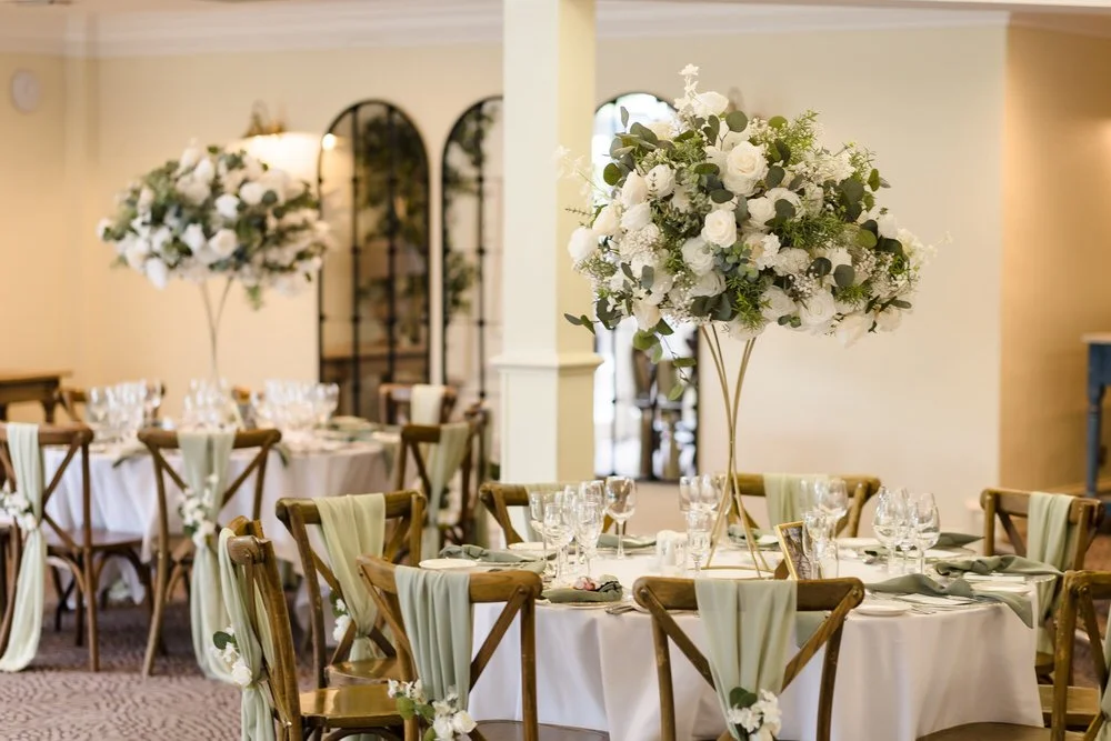 Sage green and white floral reception table styling in the Garden Room at Hogarths Stone Manor