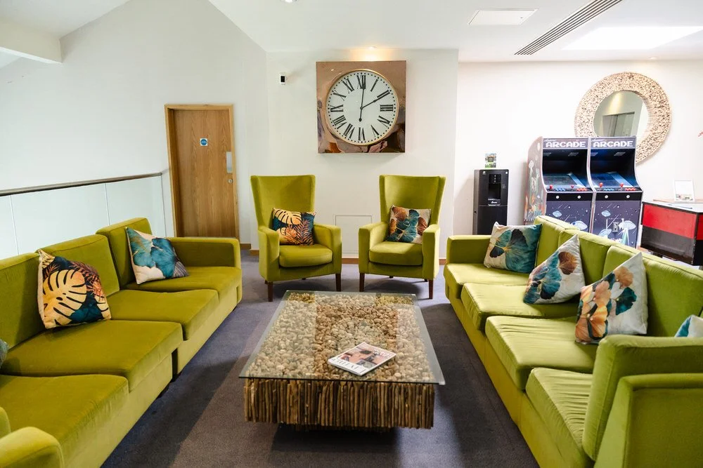 Guest lounge area with arcade games at De Vere Cotswold Water Park