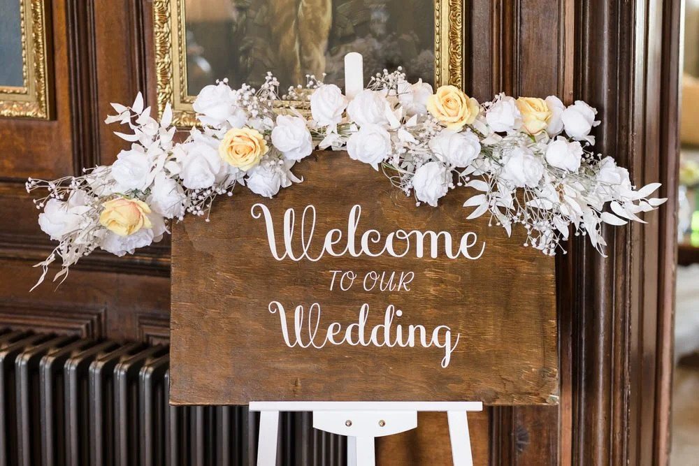 Welcome to our wedding sign with white and yellow rose details inside Rowton Castle