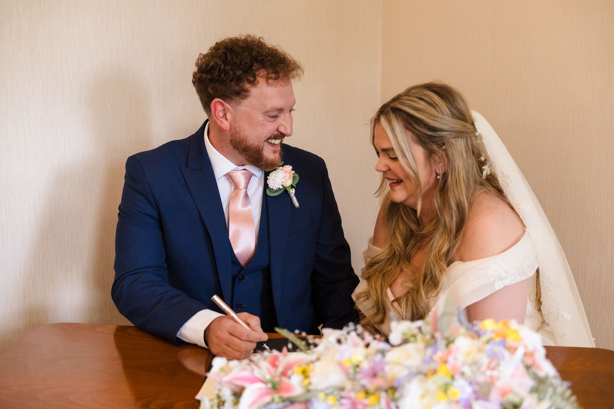 The couple signing the register at Lichfield Registry Office, wedding photography by Once in a Lifetime Photography.