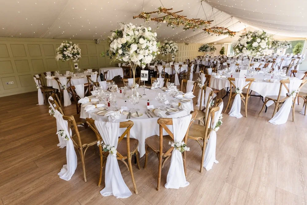 Elegant wedding reception tables with tall floral centrepieces at Hogarths Hotel wedding venue.