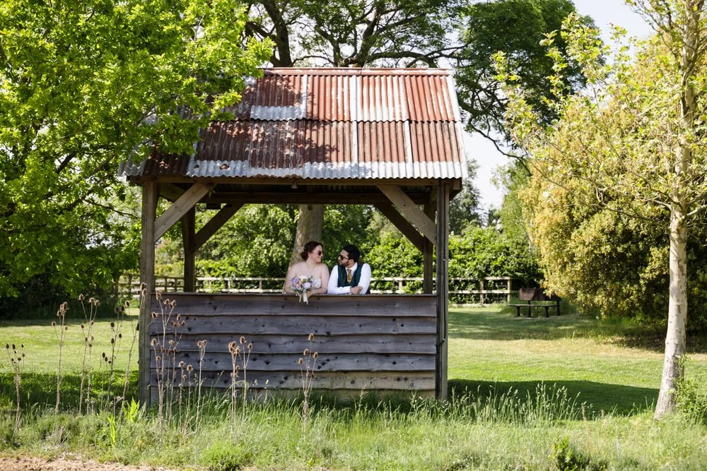 Bride and groom sharing a quiet moment inside The Shed at Huntsmill Farm, Buckinghamshire.