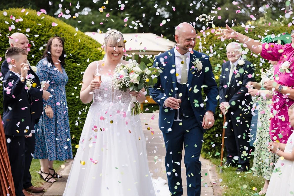 Confetti and group photographs in the walled garden at Hogarths Stone Manor, Worcestershire