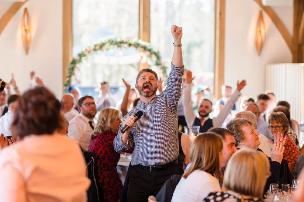 wedding guests cheering after speech