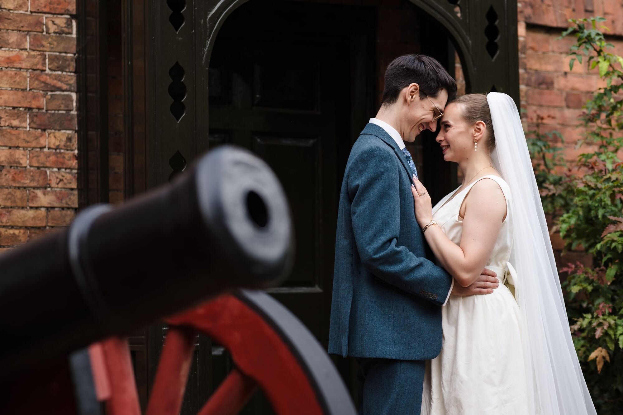Isabelle and Chris forehead to forehead behind a Civil War cannon at The Commandery, Worcester, by Once in a Lifetime Photography