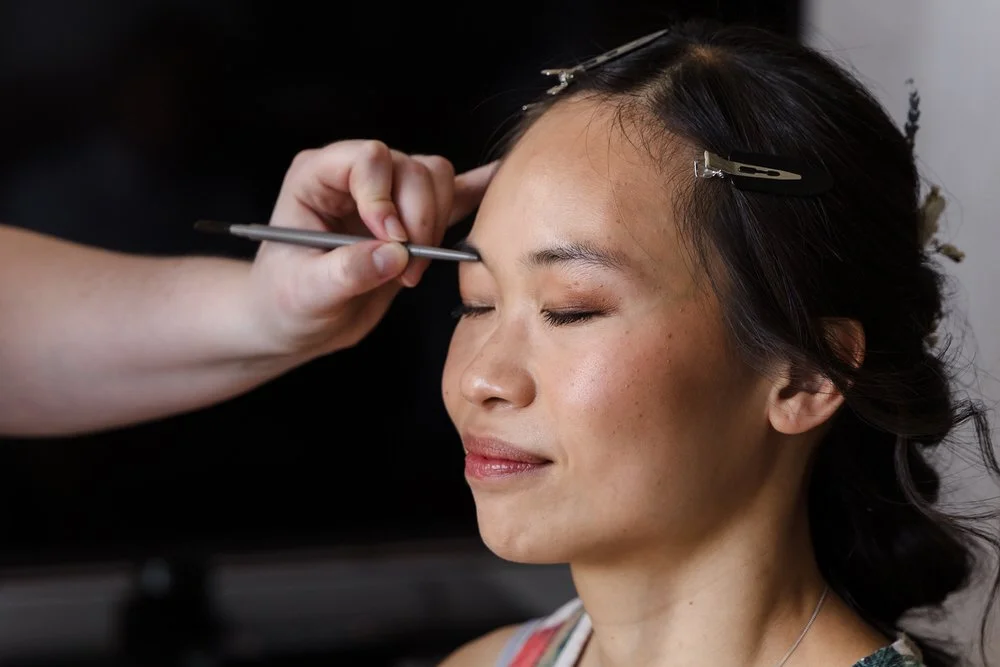 Close-up of bride Christine having her eye makeup applied during wedding morning preparation at The Welcombe Hotel.