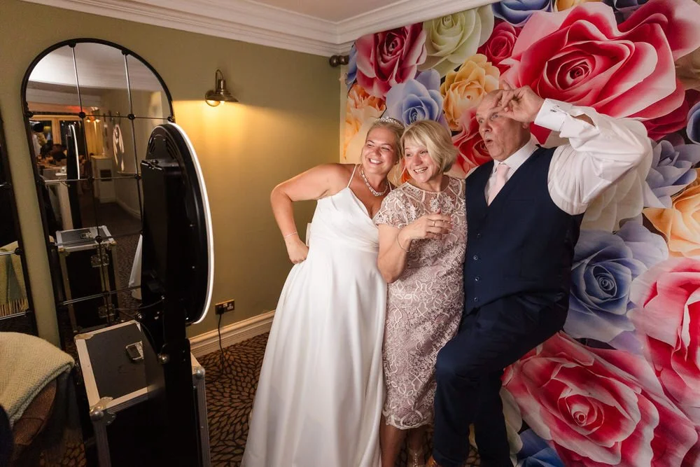 Guests in photo booth at Hogarths Stone Manor wedding by Blue Diamond Entertainment, candid photography