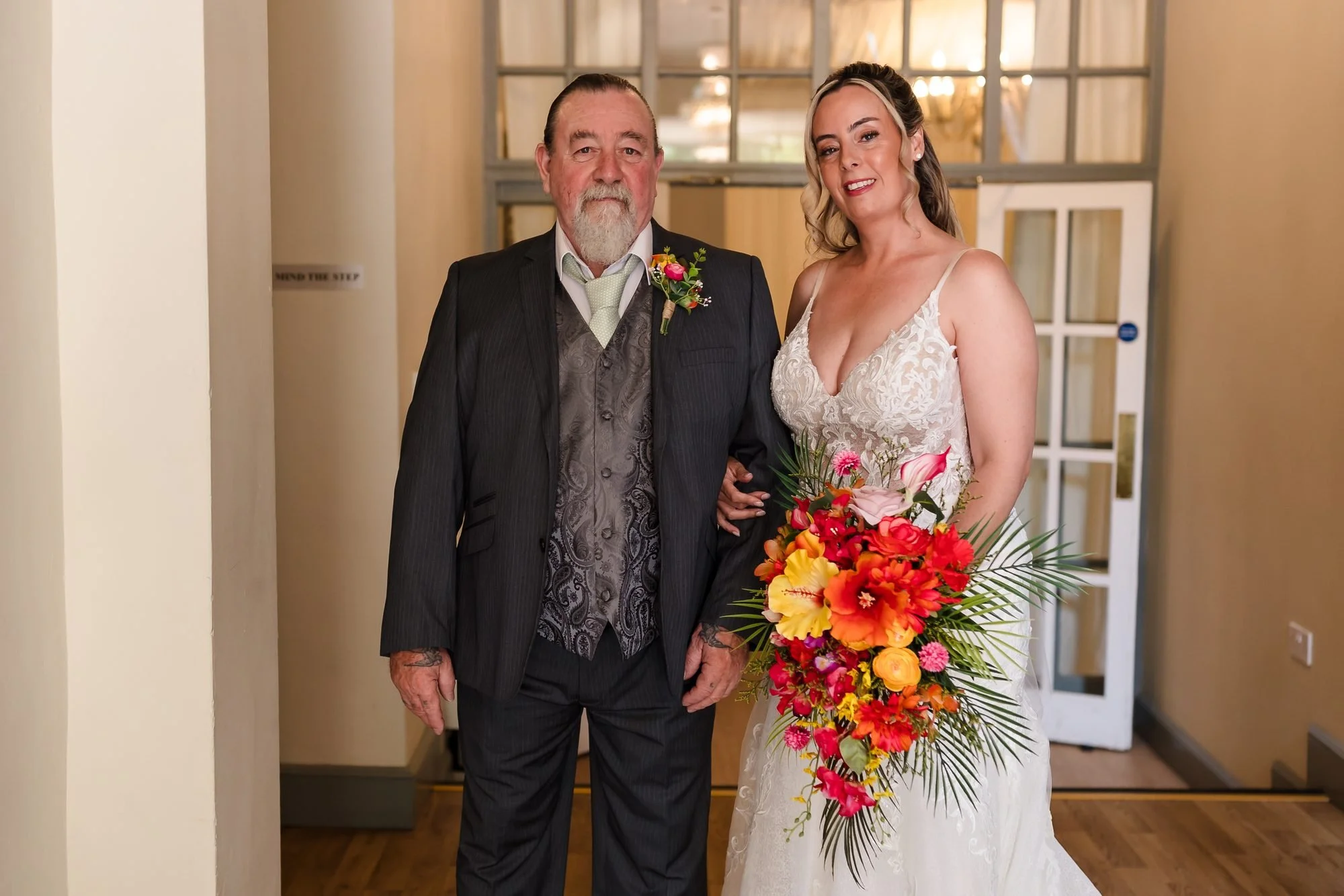 Bride Angela with her dad and her tropical bouquet, moments before walking down the aisle at Warwick House
