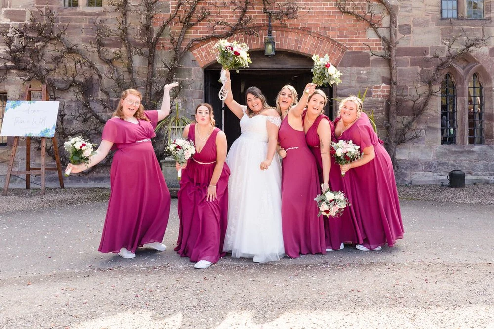 Bridesmaids dancing at a wedding with bouquets