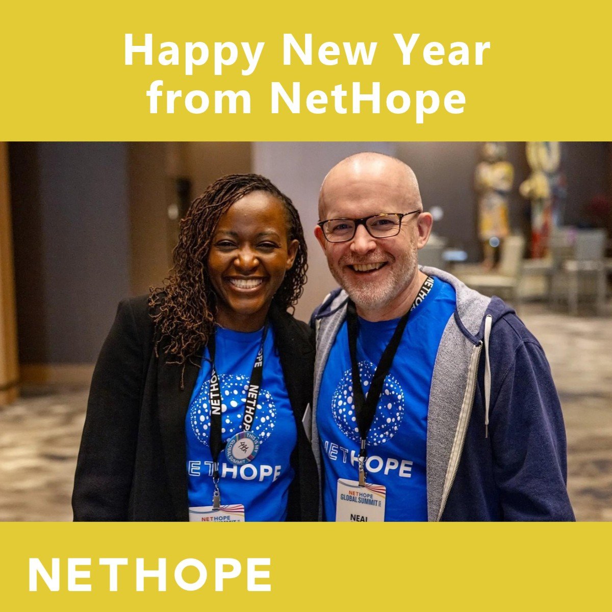 NetHope New Year post: two NetHope Global Summit attendees in NetHope shirts smiling together