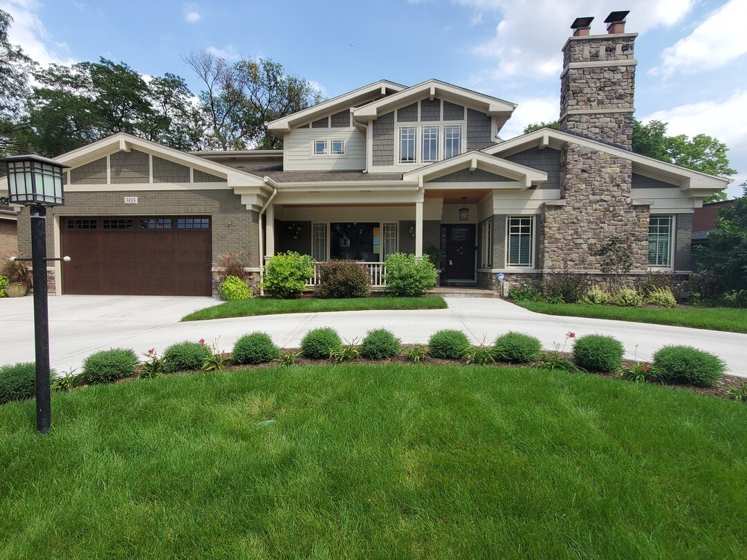 We are loving the result of this gorgeous Elmhurst home repaint! The brick was painted to match the siding. It really makes the natural stone chimney stand out along with the contrast of the trim color #exteriorpainting #colorinspiration