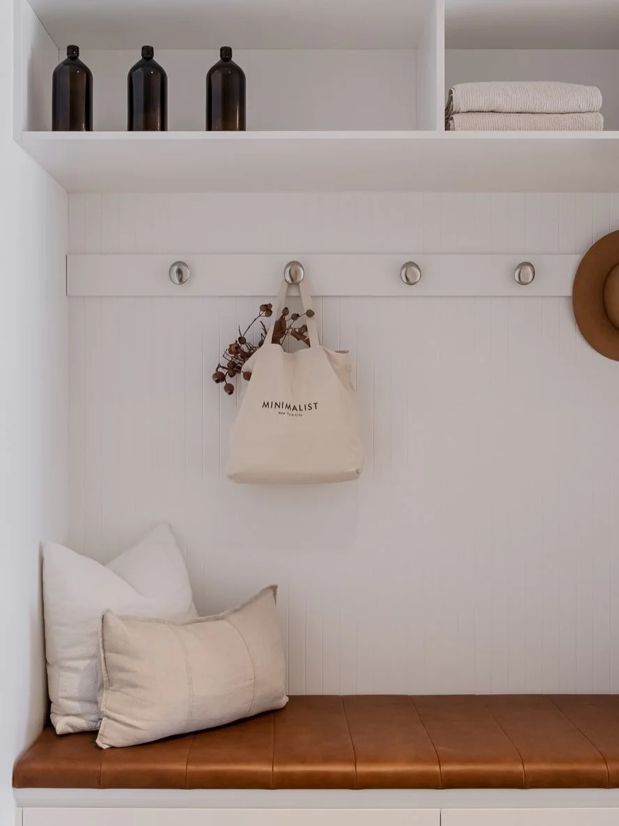 We designed this clever combo mudroom&ndash;laundry that makes the most of every bit of space, bringing calm and organisation into the everyday rush. 

Clean white joinery is paired with black mesh accents for a little texture and contrast, while the