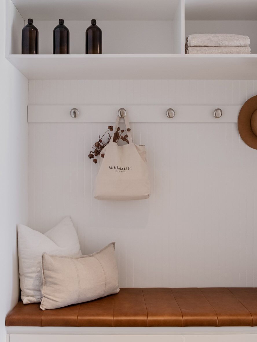 We designed this clever combo mudroom&ndash;laundry that makes the most of every bit of space, bringing calm and organisation into the everyday rush. 

Clean white joinery is paired with black mesh accents for a little texture and contrast, while the
