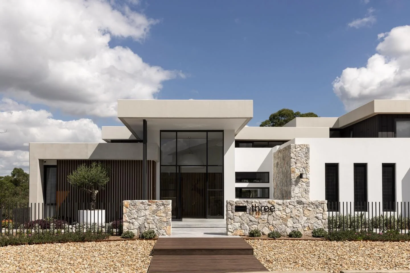 The brief for the Lindeman Project was simple, but not small.

Create a family home that could entertain beautifully, function properly and still feel calm to live in.

It had to work with a steep site, capture the bush outlook, bring natural light i