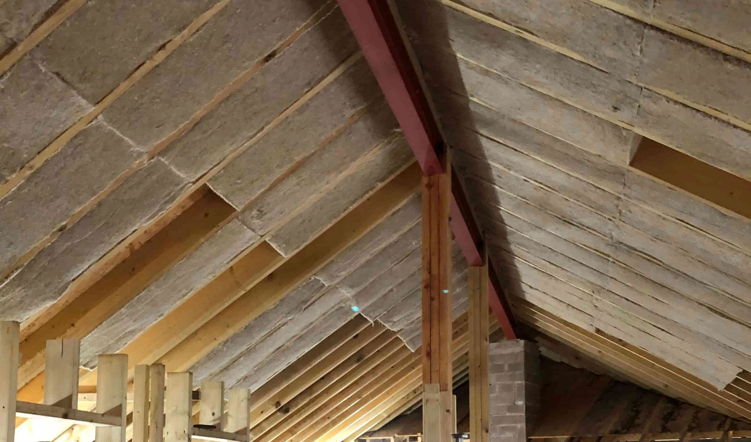Photo of IndiNature insulation installed between timbers in a roof