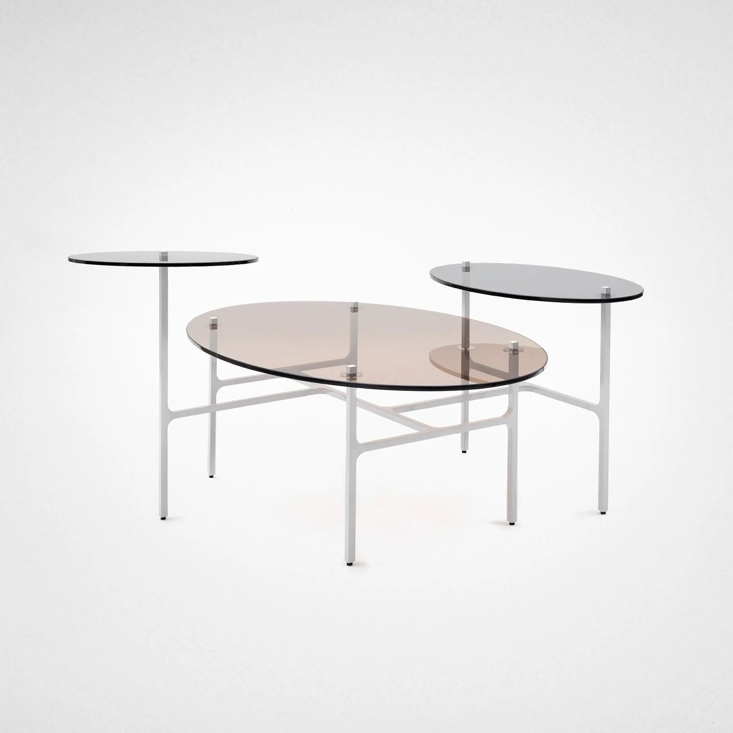LUNA nesting table 
by @lumifer_by_javierrobles 
The interlacing of the brass “T” legs punctuating the tinted round and oval glass discs brings queues of movement and playfulness to this multilevel nesting table.
MATERIALS:
Tempered Tin