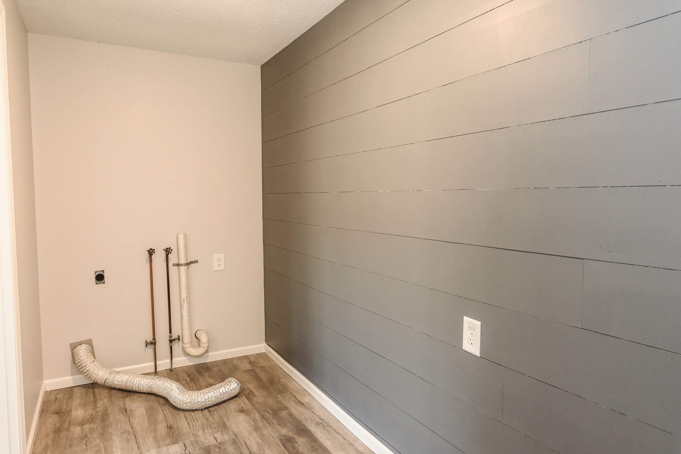 Shiplap Laundry Room with Wood Floor