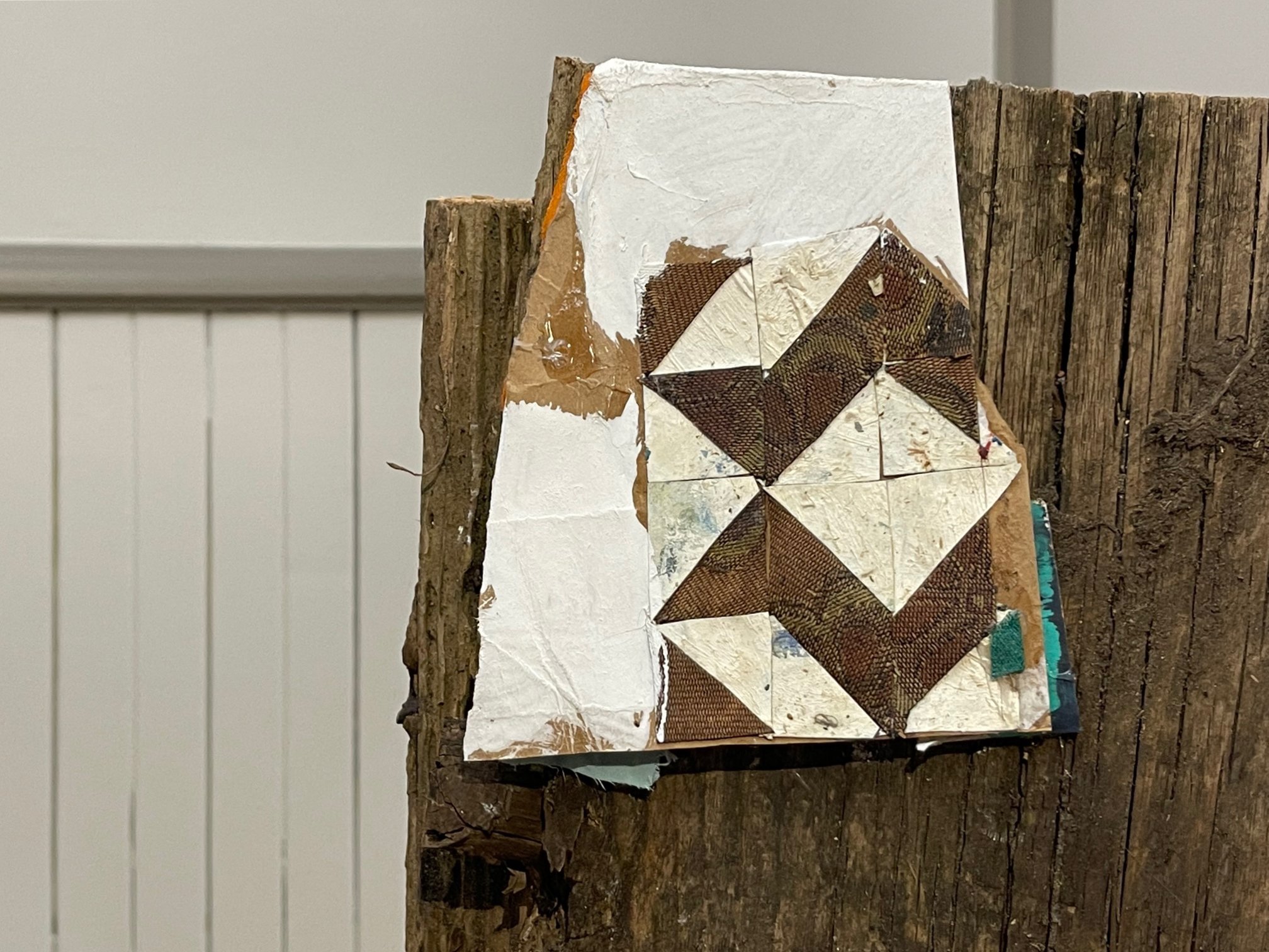  Detail image for “Untitled.” Textile, house paint, cardboard, wood from a 120-year-old home from the local community. Photo by Edra Soto.  