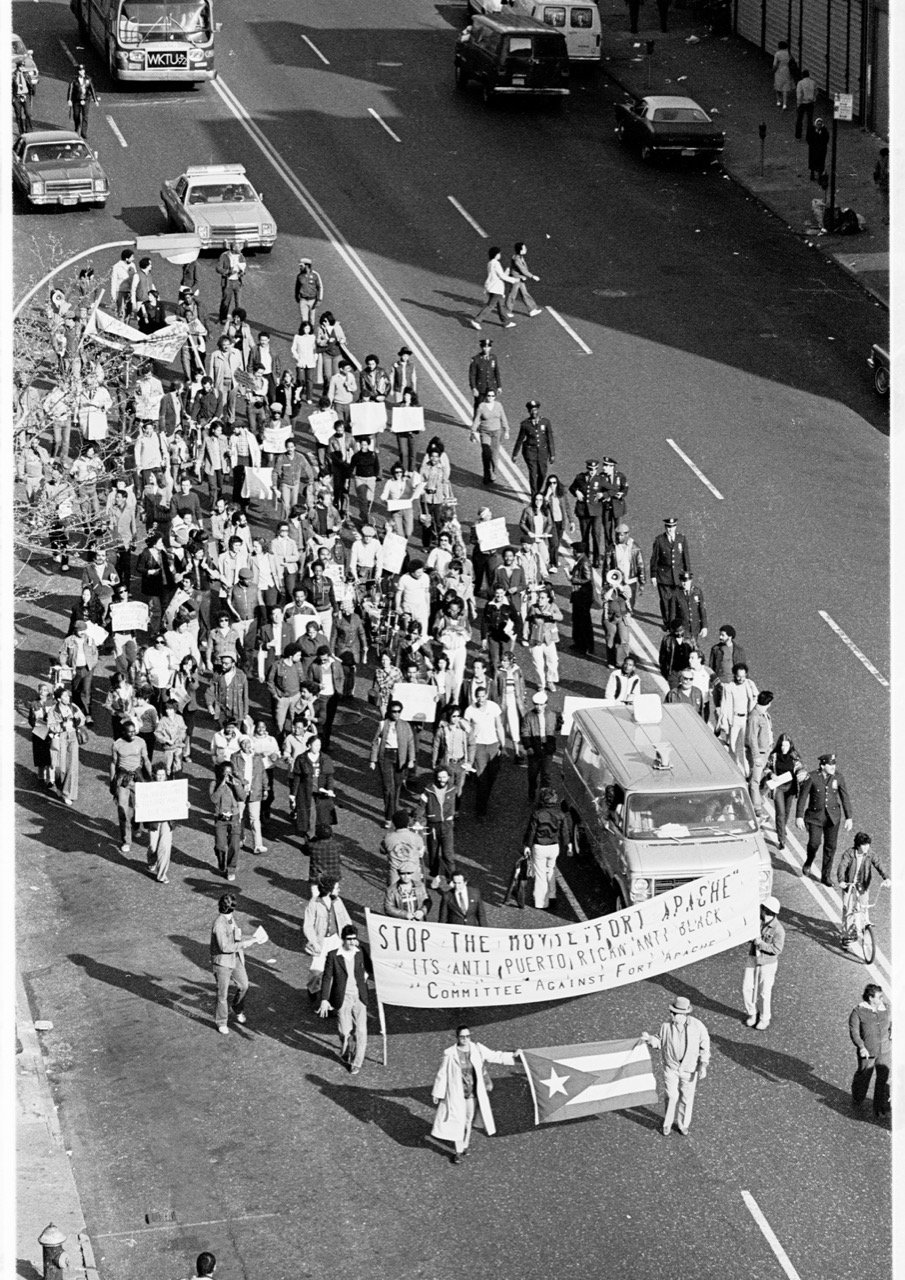 Community members march in protest against the film Fort Apache. 