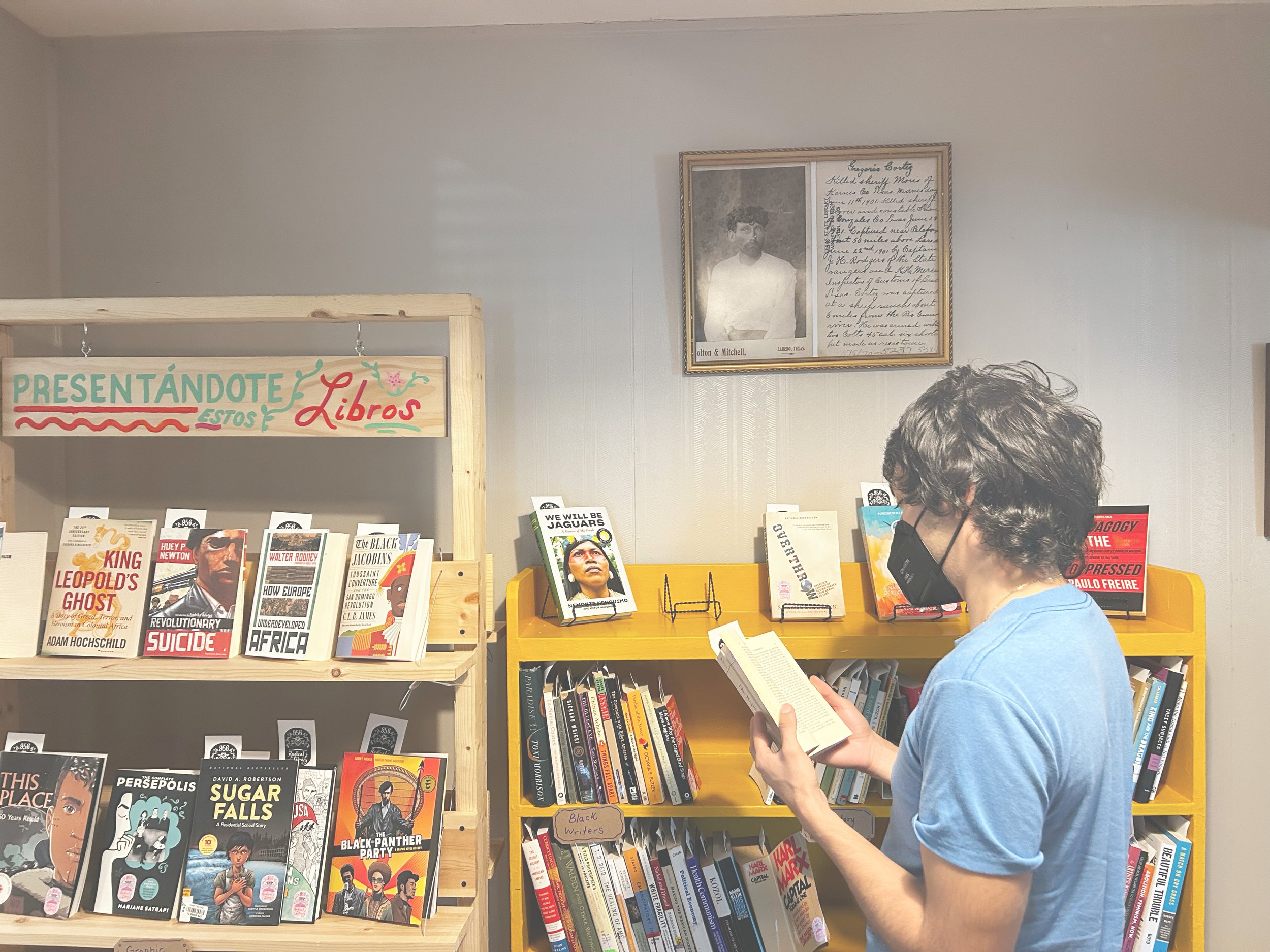 A person standing in front of books