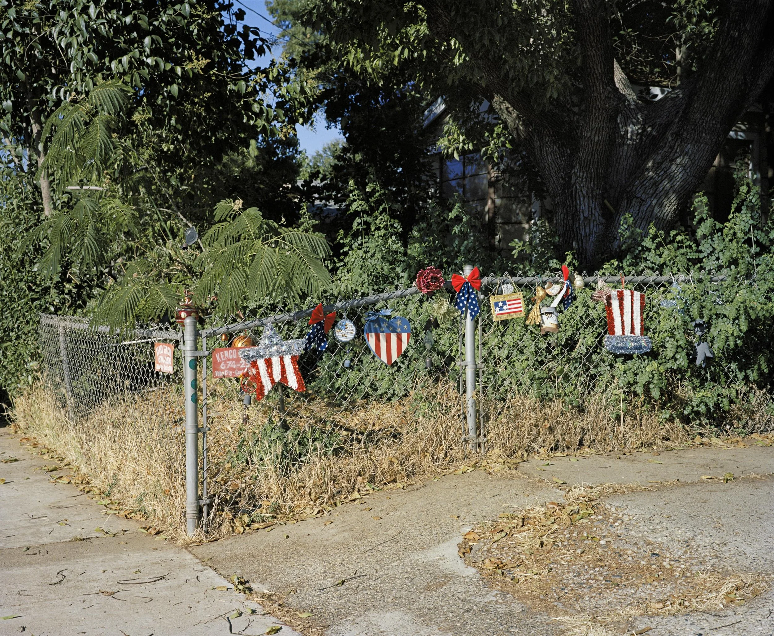 a chainlink fence decorated with US-themed decorations