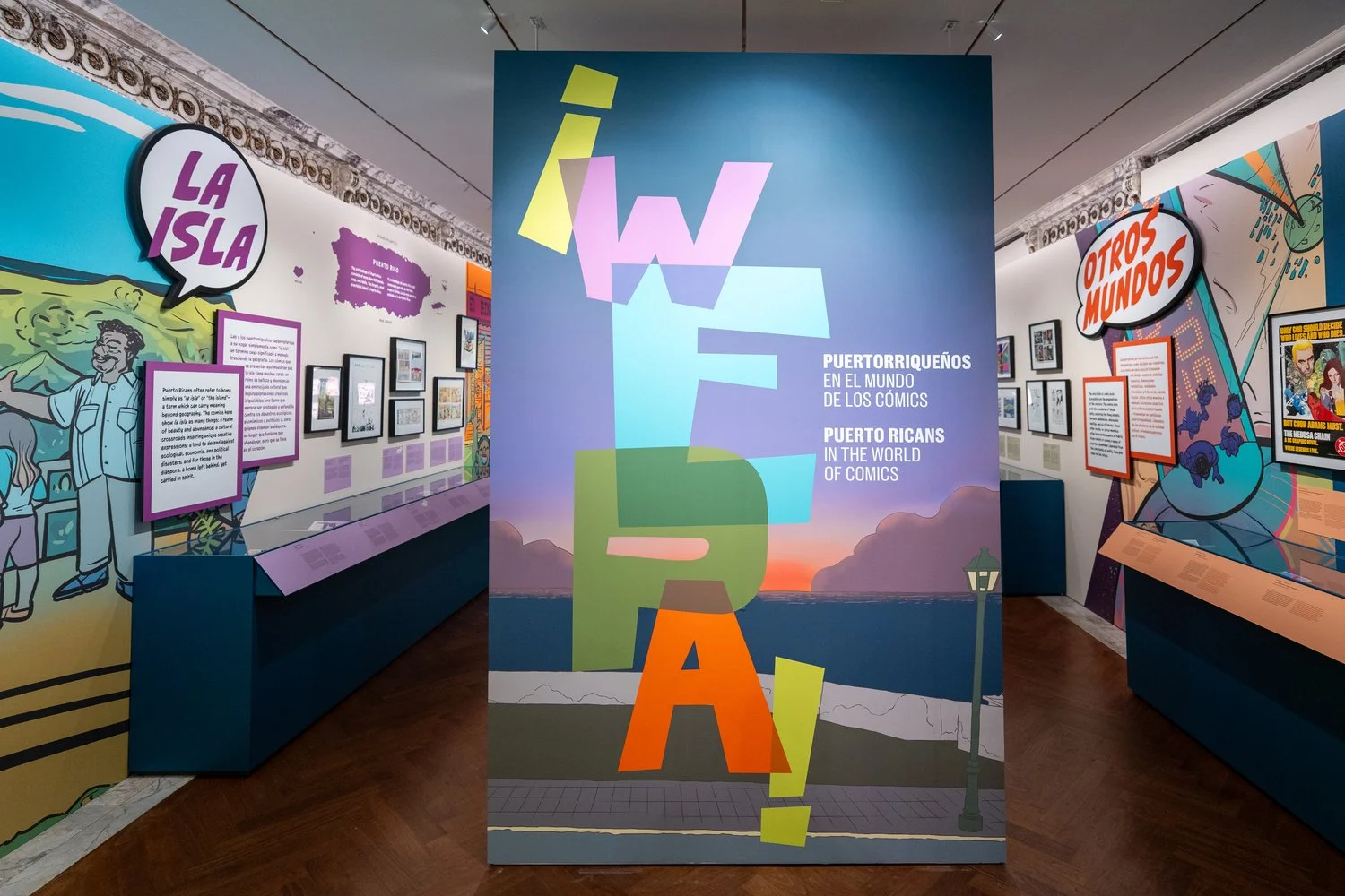 exhibition space with the words "wepa" "la isla" and "otros mundos" visible