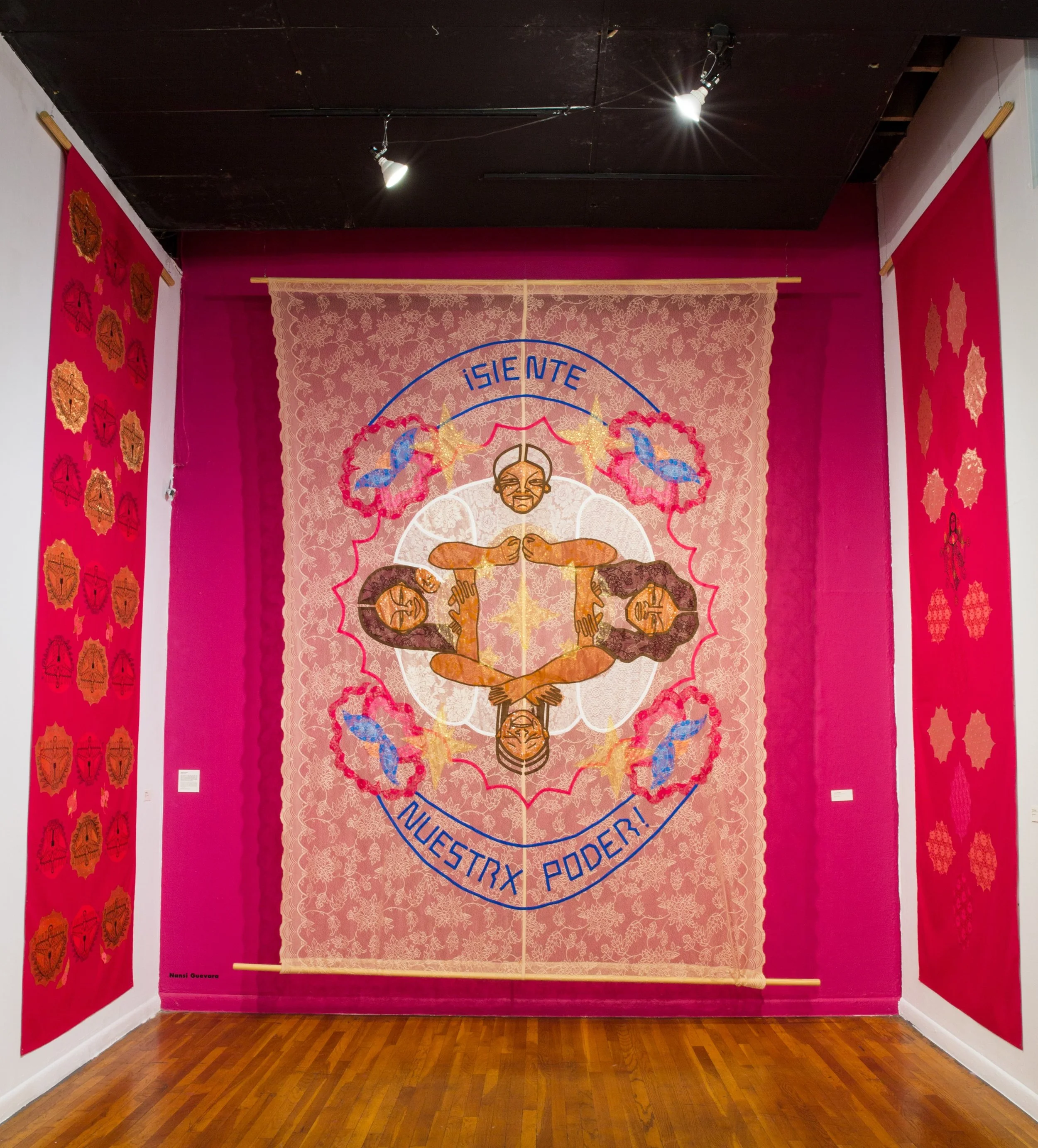 fabric collage with the words "siente nuestrx poder" on it