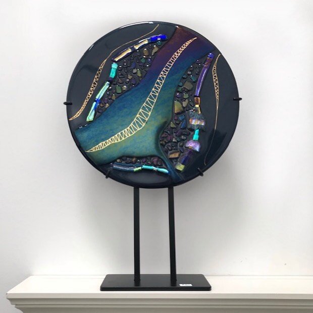 From Katherine Stewart&rsquo;s gallery : JEWELS OF THE WORLD
approximately 19&rdquo; high with stand and 12&rdquo; wide. 12&rdquo; circle with iridescent and dichroic embellishments - find out more at https://www.theartnexus.com/artists/katherinestew