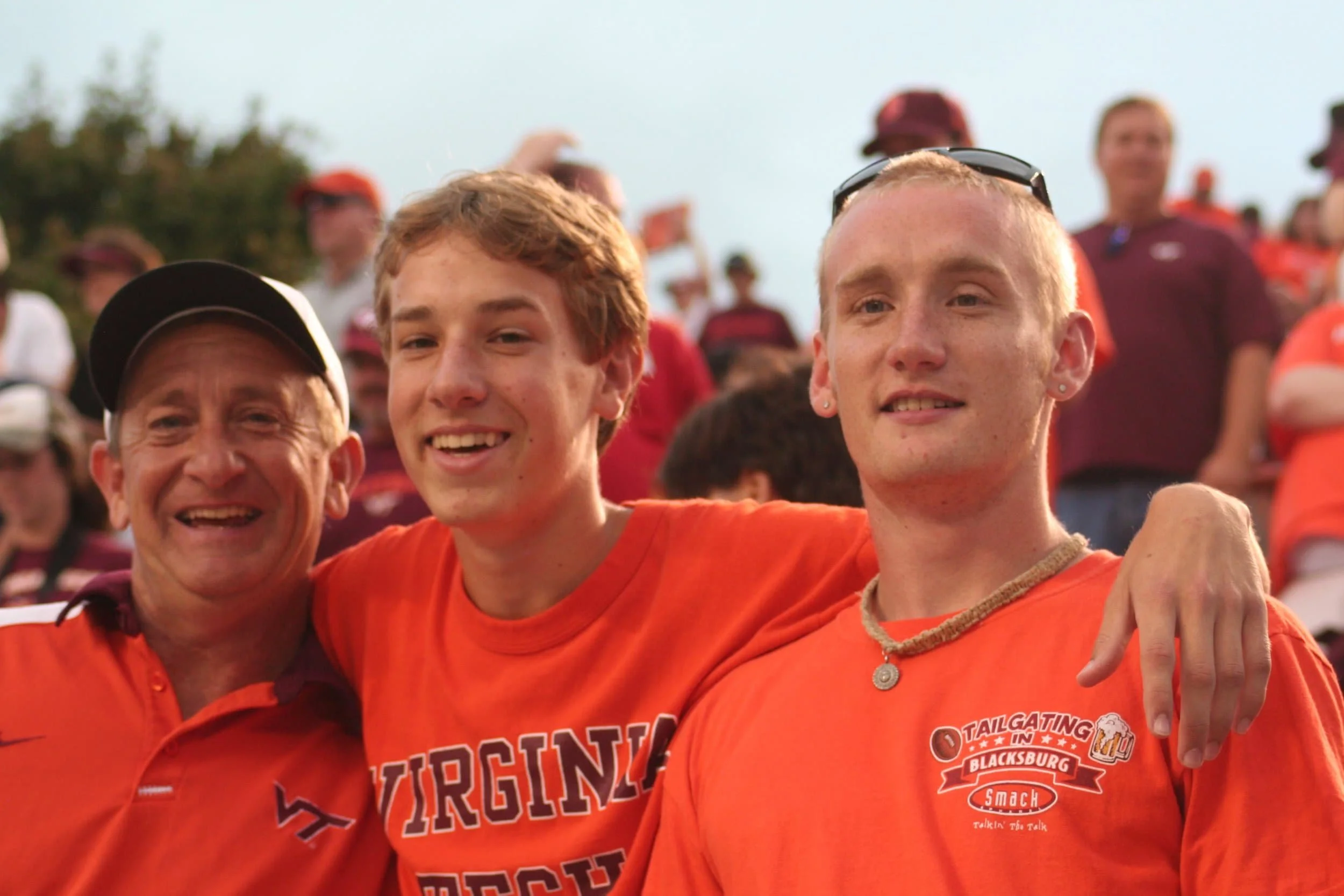 3 members of the Chrisman family in Hokie gear at a Virginia Tech football team