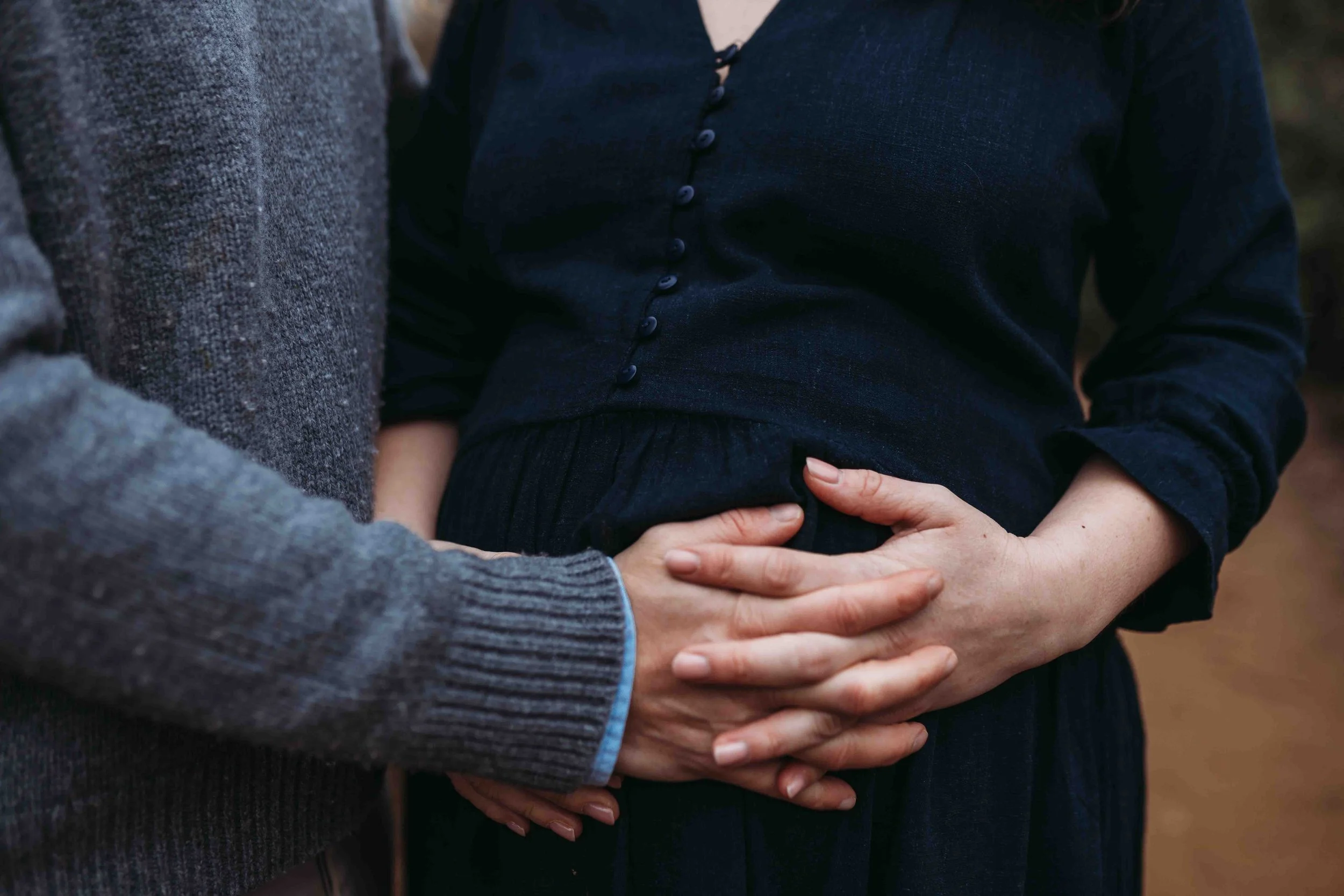 hands on bump at winter maternity photoshoot in Richmond Park