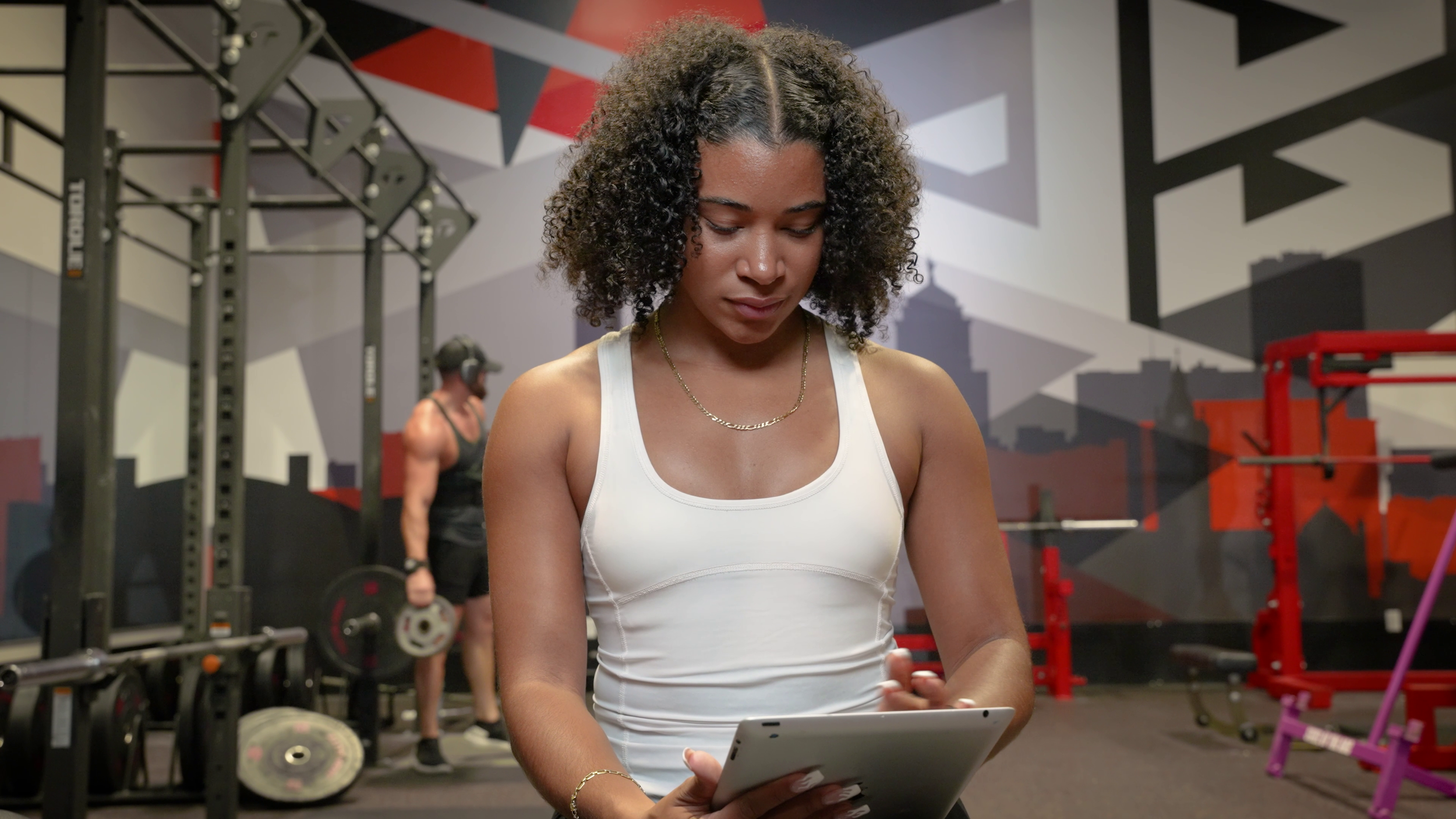 Woman using tablet in gym