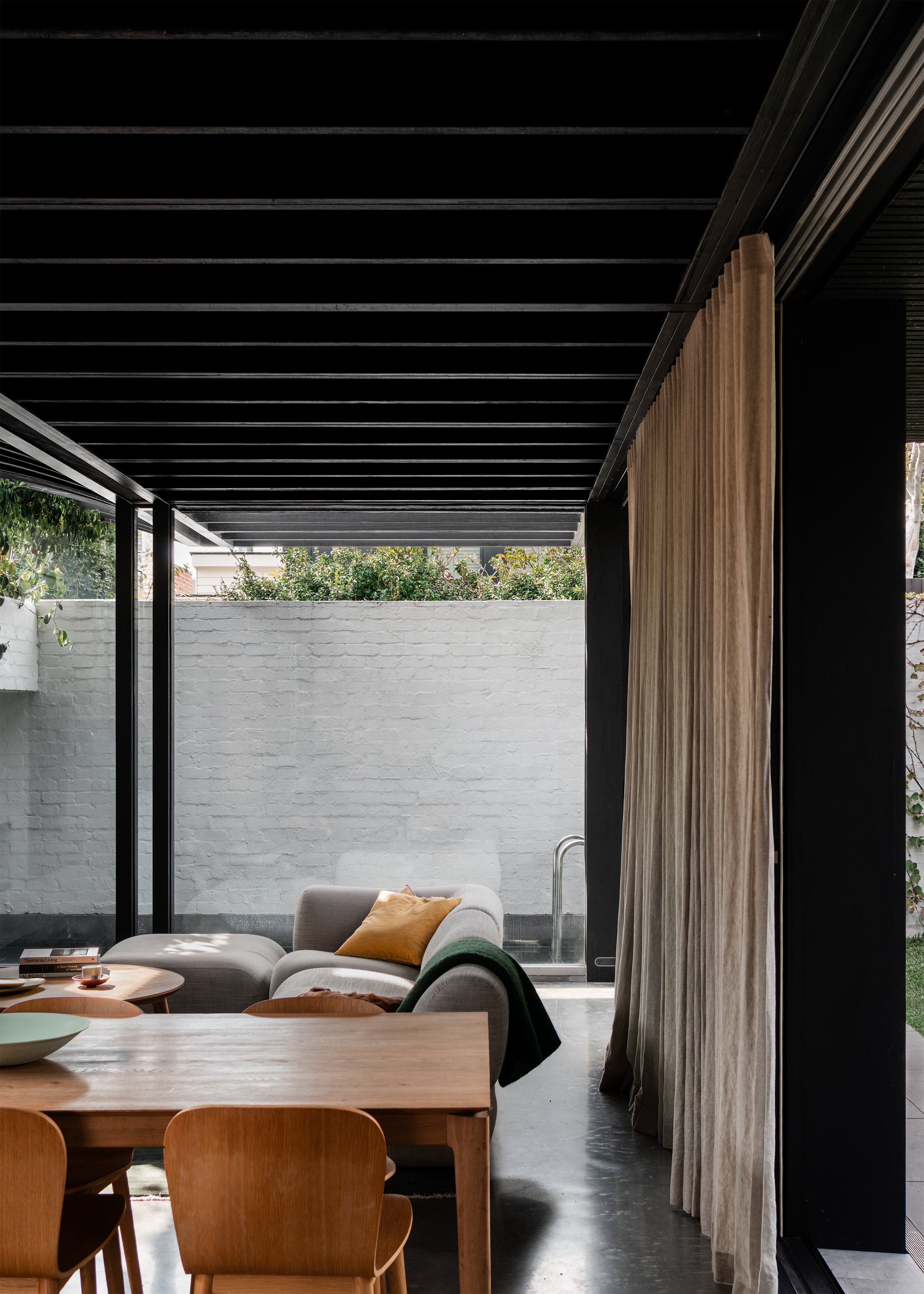 Dining and living room opening to garden and pool in this Albert Park house extension.