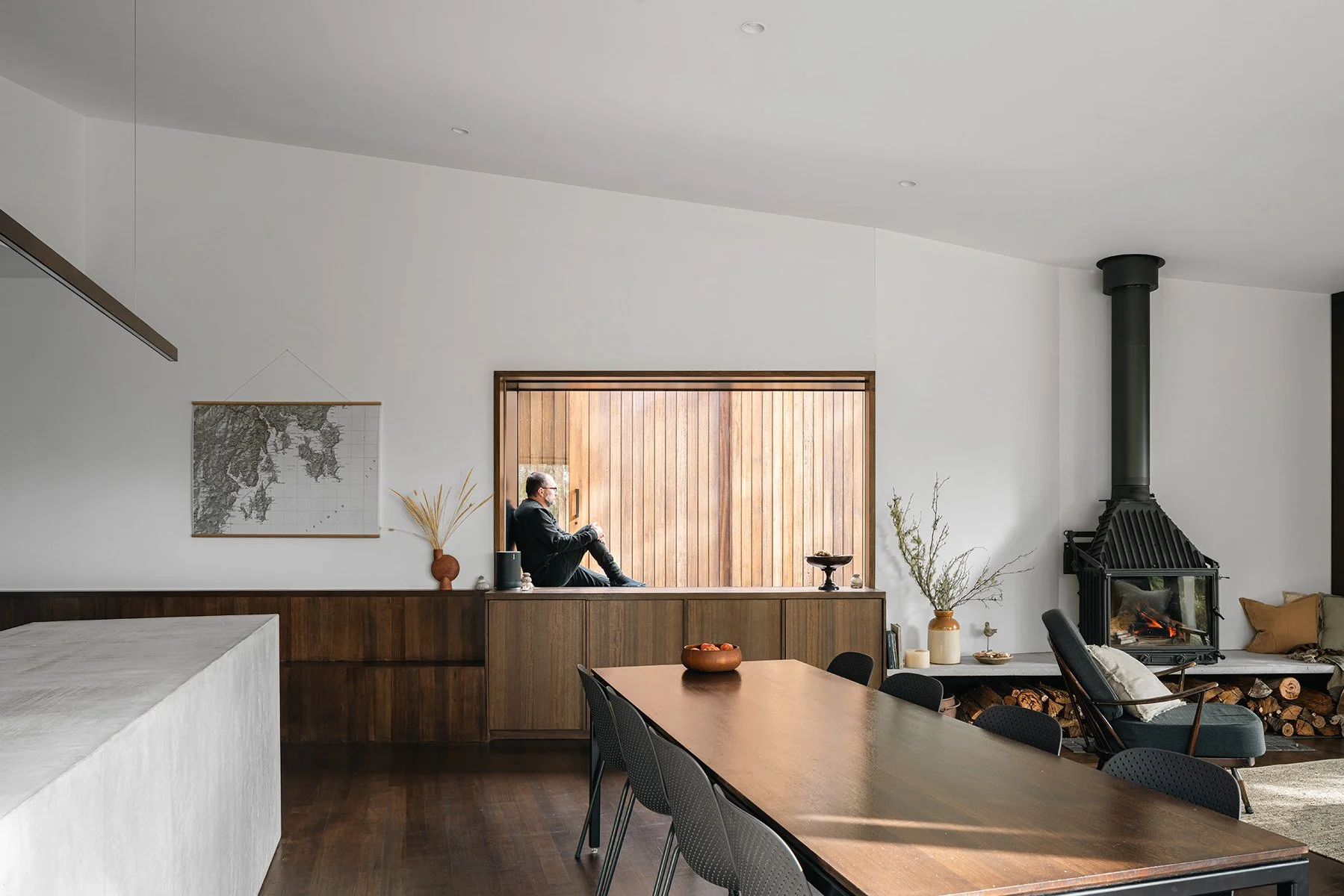 Open-plan kitchen, dining and living area inside Killora Bay, a Tasmanian bushland house by Lara Maeseele.