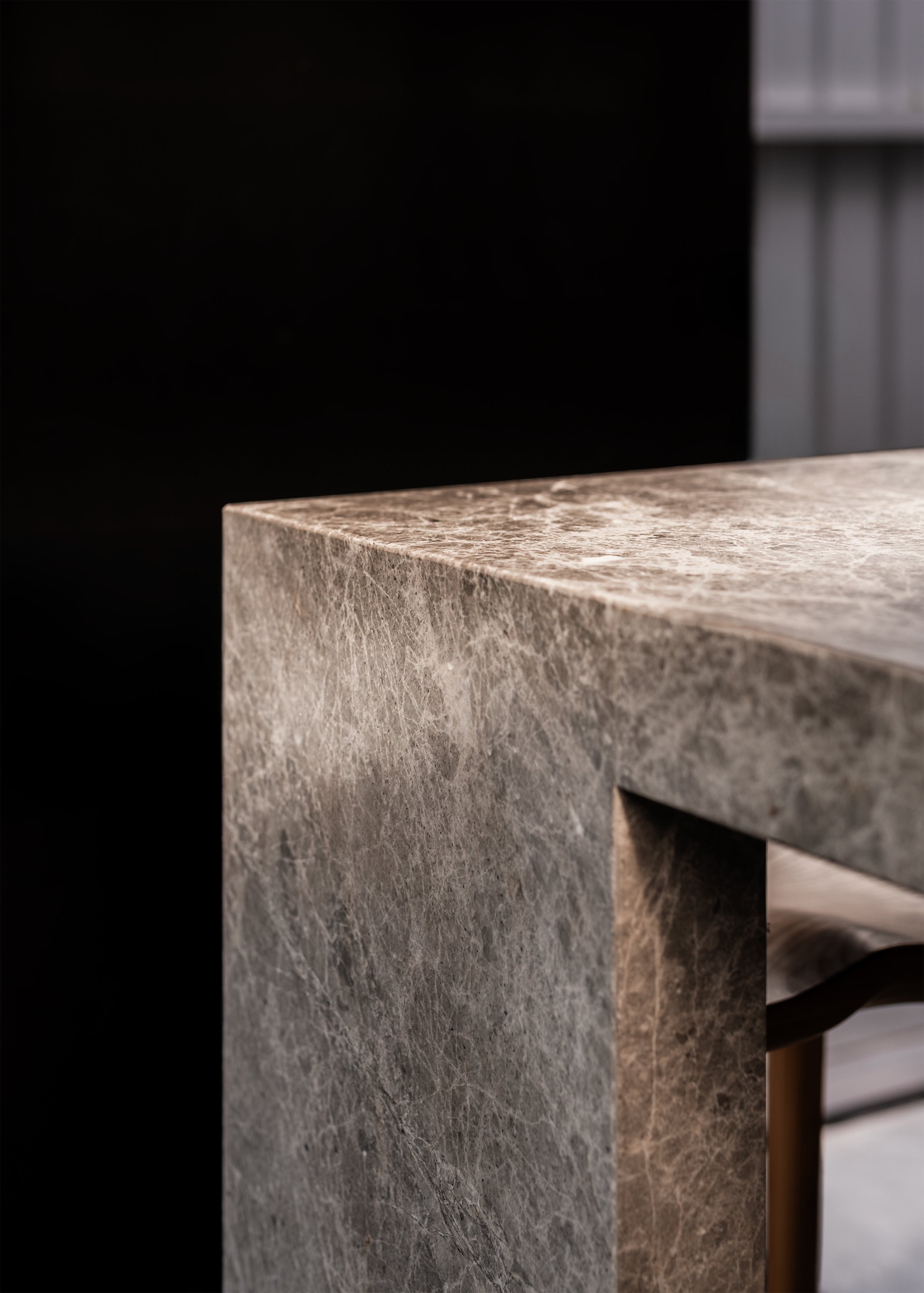 Close detail of the stone kitchen island and its textured surface at Borrowed Garden House designed by Topology Studio.