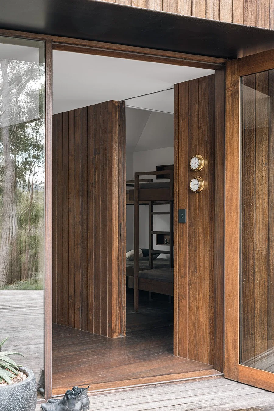Timber-lined entry to Killora Bay on Bruny Island, with the custom bunk bedroom visible beyond the outdoor deck.