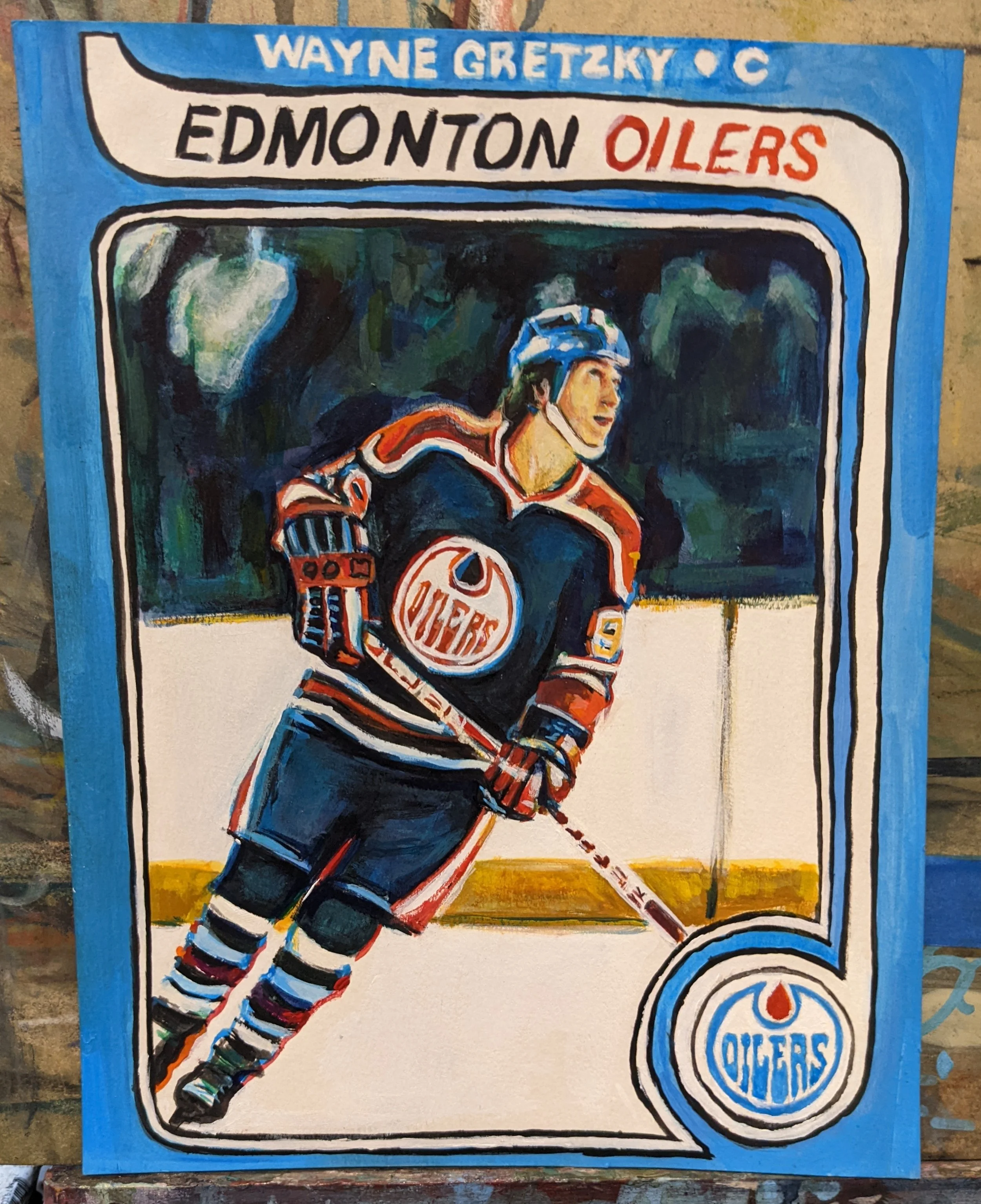 Painting of a hockey player in an Edmonton Oilers jersey skating on ice, with a hockey stick, wearing a helmet, against a background of a hockey rink and trees. The border includes the Edmonton Oilers logo and the names 'Wayne Gretzky' and 'Edmonton 