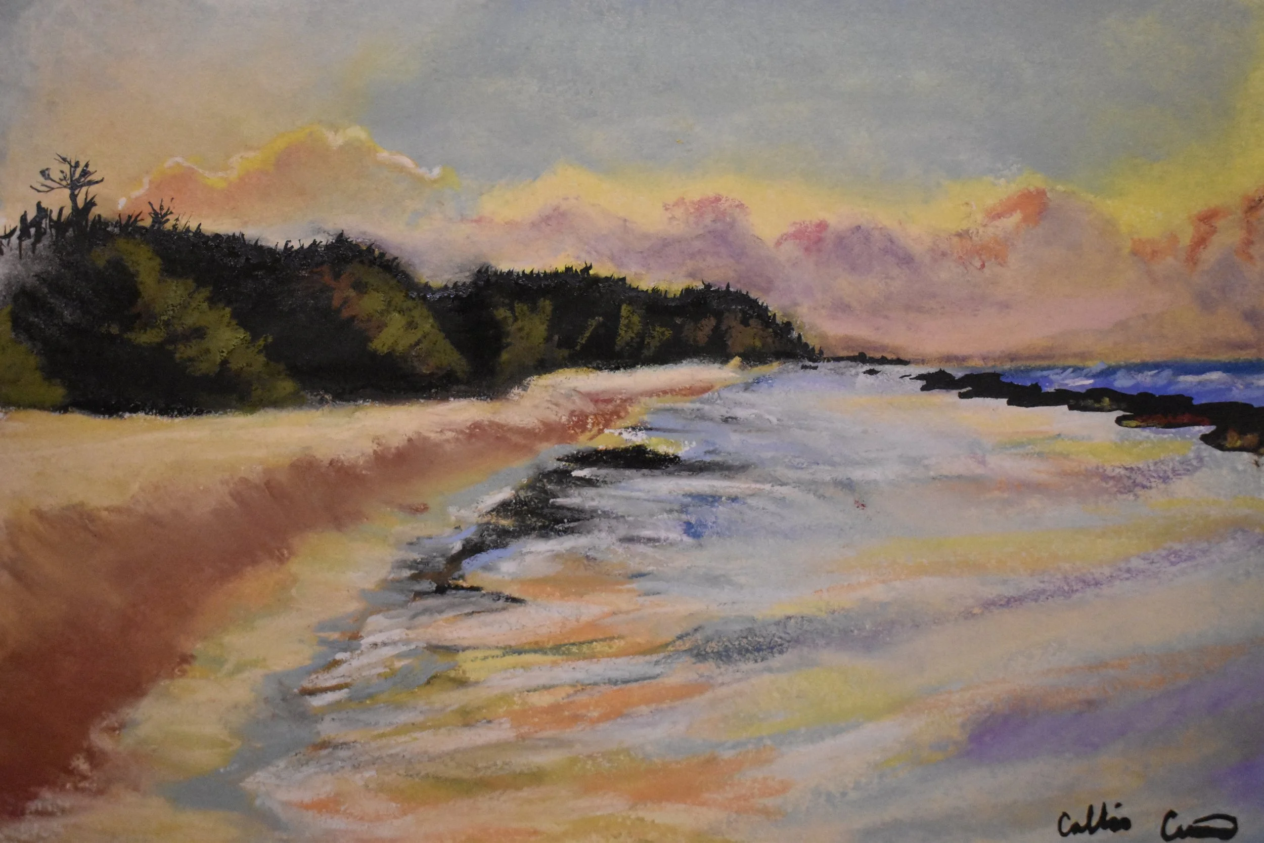 A colorful watercolor painting of a seascape at sunset, featuring a sandy beach with gentle waves, dark rocky formations along the shoreline, lush green hills in the background, and a sky with warm hues of pink, orange, and yellow.
