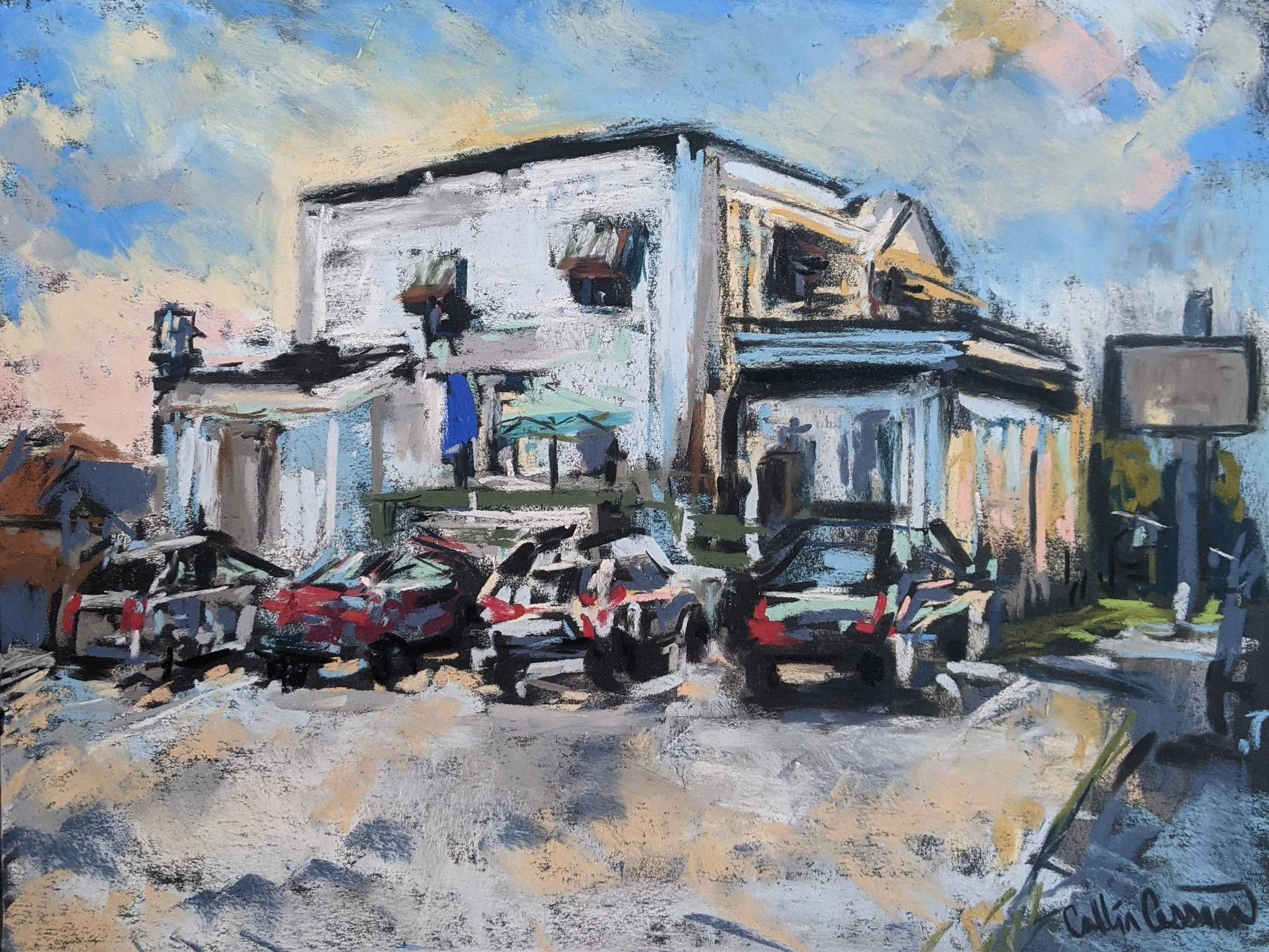 Impressionist painting of a street scene featuring a white multi-story building with balconies, several parked cars, a sidewalk with a parked bicycle, and a cloudy sky in the background.