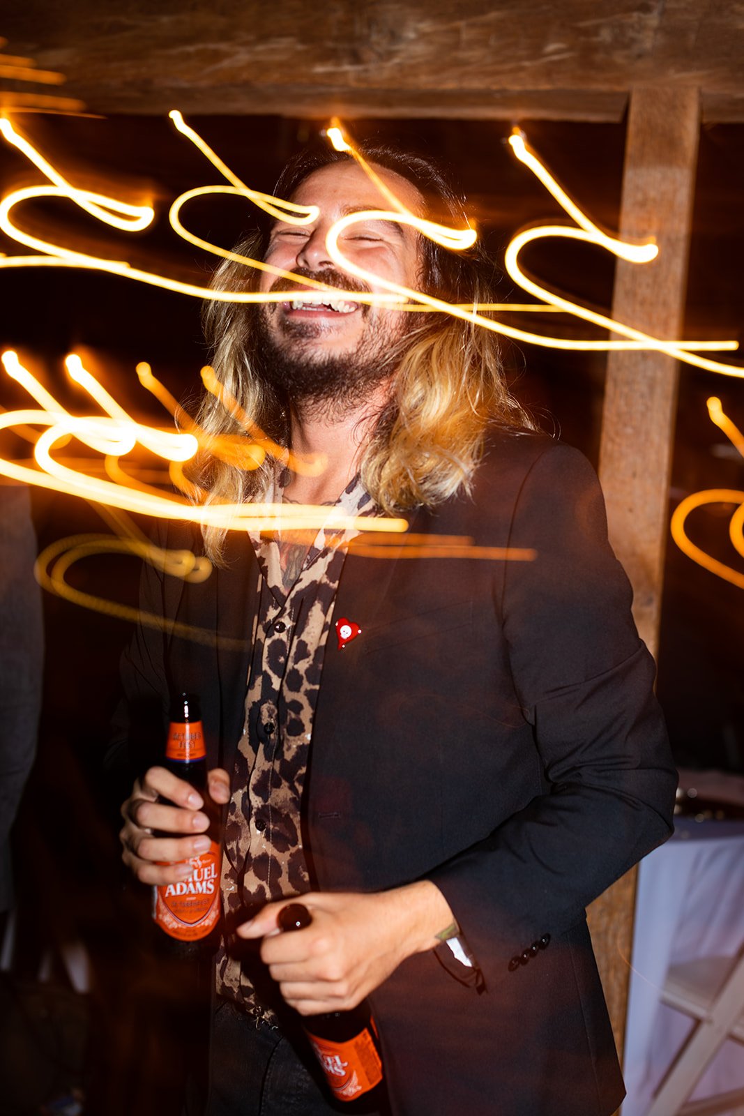 KirstenChris-wedding-reception-guest-singing-beers-light-trails-long-exposure.jpg