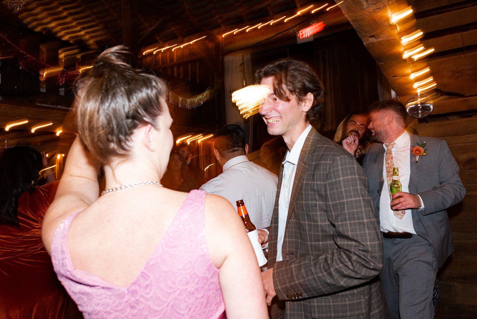 KirstenChris-barn-wedding-reception-guests-dancing-talking-long-exposure.jpg