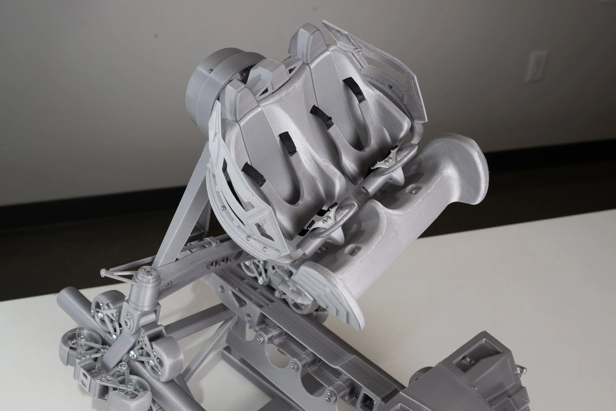 An image of the seats and restraints of a 3D printed model of the S&S AXIS coaster.