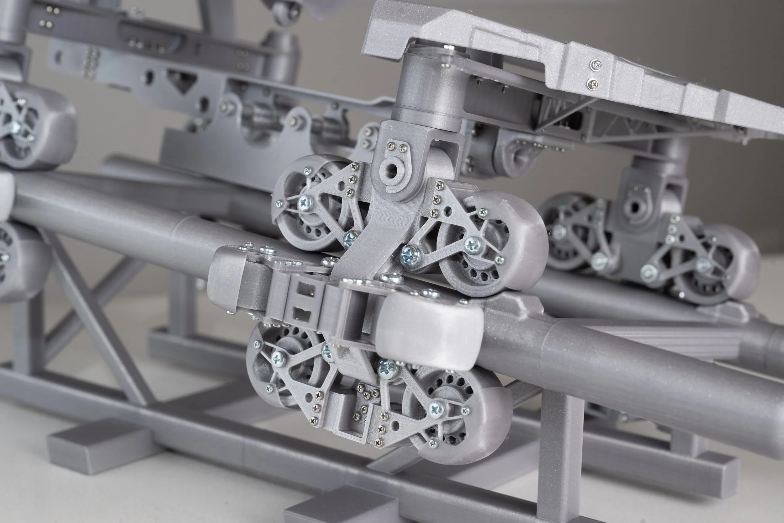 An image of the wheel carrier of a 3D printed model of the S&S AXIS coaster.